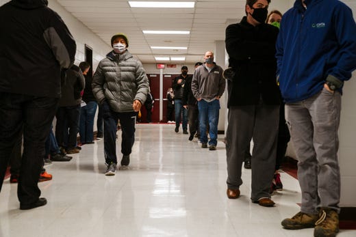 Voters wait in line to enter the polling place at Ballard High School on November 3, 2020 in Louisville.