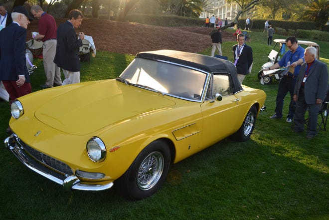 Judges take a look at Jacksonville resident Rodolfo Junco de la Vega’s (right)  yellow Ferrari 275 GTS at the 2015 Amelia Island Concours. The car is the prototype for the classic convertible model.