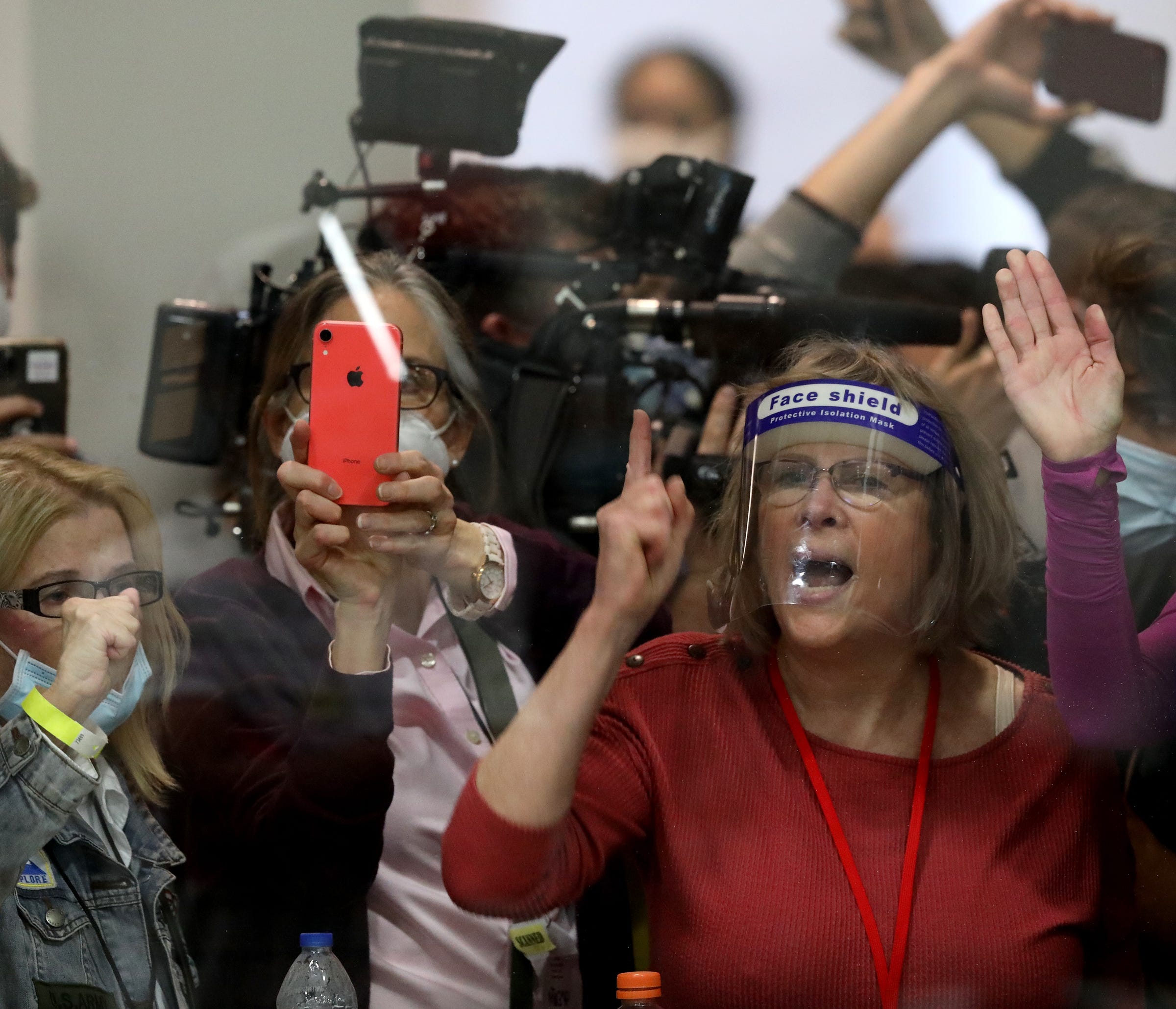 People outside of the ballot counting area bang on the windows chanting "let us in and stop the count" at the TCF Center in Detroit on Nov 4, 2020.