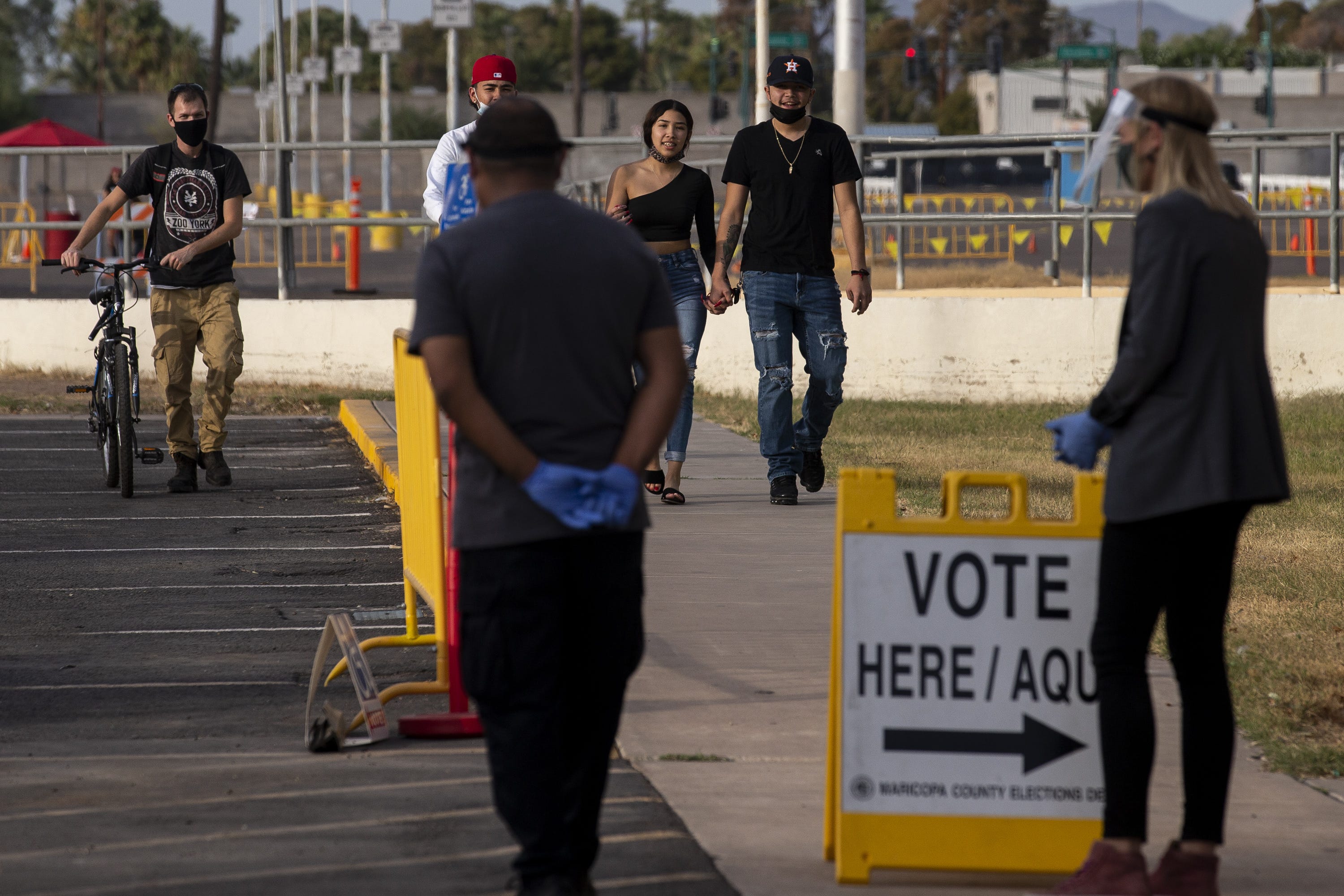 People walk to vote at the Arizona Veterans Memorial Coliseum in Phoenix on Nov. 3, 2020.