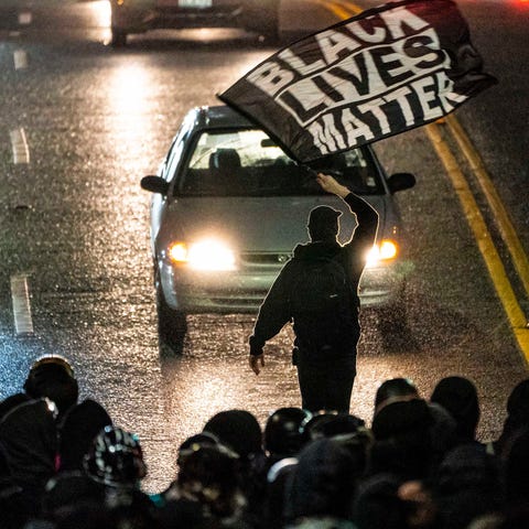A protester waves a Black Lives Matter flag during