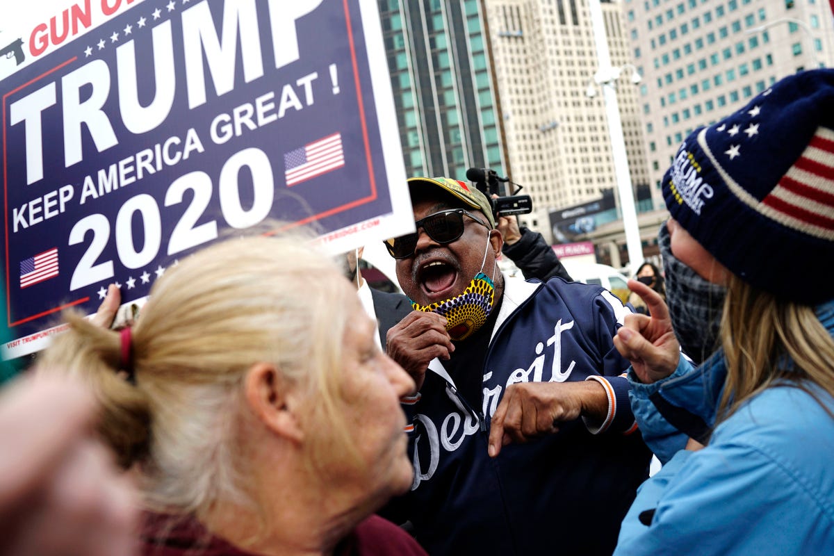 People argue their views during opposing protests at the TCF Center on Nov. 5, 2020, in Detroit. Arguments between opposing sides lasted for only a couple of minutes. The combined protests made up about close to a hundred people. 