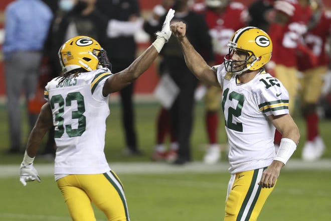 Green Bay Packers quarterback Aaron Rodgers (12) is congratulated by running back Aaron Jones (33) after throwing a touchdown pass to Marcedes Lewis during the first half of an NFL football game against the San Francisco 49ers in Santa Clara, Calif., Thursday, Nov. 5, 2020.