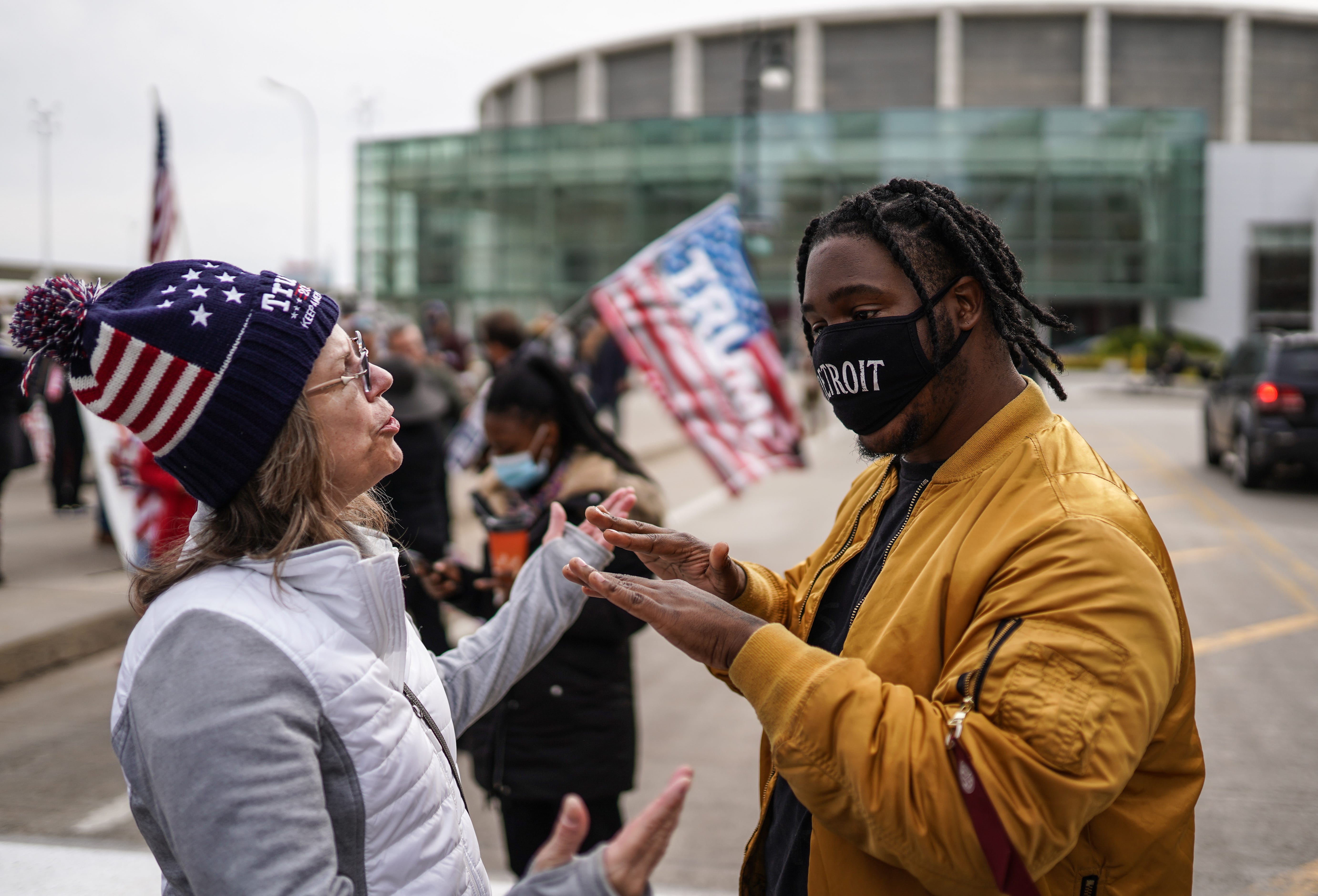 Angelo Austin, right, of Detroit asks a Trump supporter to back away from him since she isn't wearing a mask. Trump supporters gathered outside the TCF Center in Detroit on Nov. 5 as absentee ballots were counted.