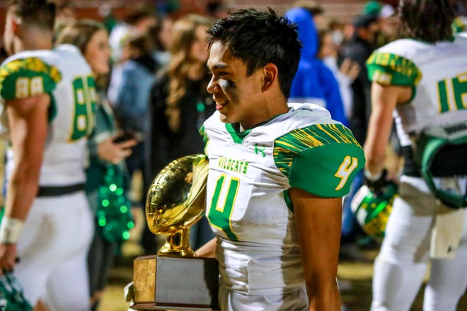 Idalou’s Ryan Lozano (4) poses with the District 4-3A Division II championship Friday, Nov. 6, 2020 after the Wildcats beat Roosevelt at Eagle Field in Acuff, Texas.