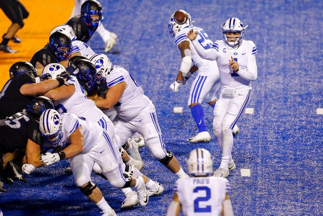 BYU quarterback Zach Wilson (1) throws the ball to BYU wide receiver Neil Pau'u (2) for a 1 yard touchdown against Boise State during the second half in an NCAA college football game Friday, Nov. 6, 2020, in Boise, Idaho. BYU won 51-17. (AP Photo/Steve Conner)