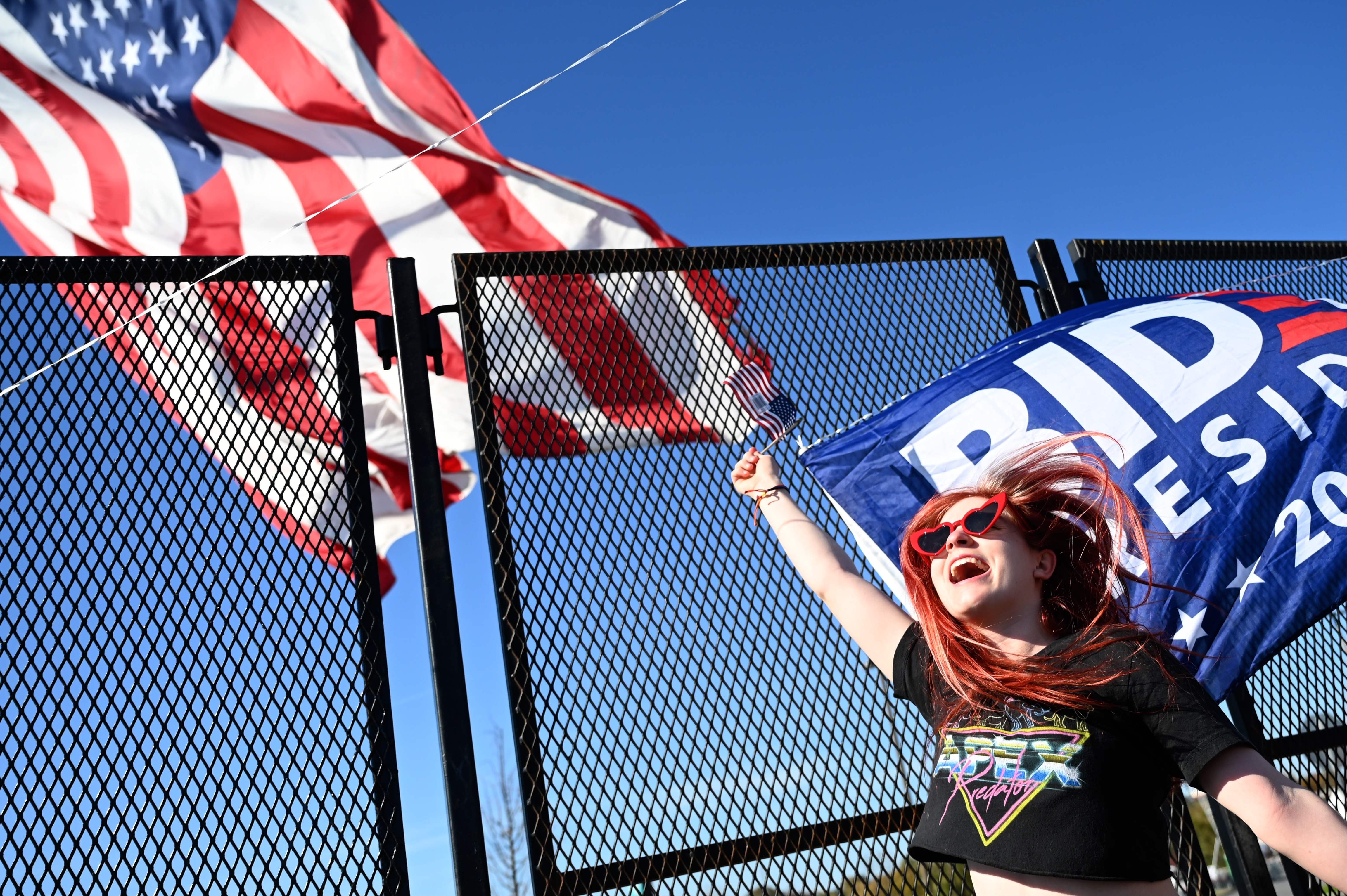 A supporters of President-elect Joe Biden waves a flag in celebration in Wilmington, Delaware.