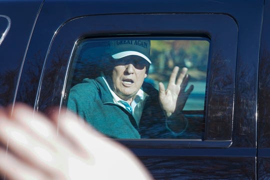 President Donald Trump waves to supporters as he departs after playing golf at the Trump National Golf Club in Sterling Va., Sunday Nov. 8, 2020. (AP Photo/Steve Helber)