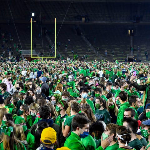 Fans storm the field after the Notre Dame Fighting