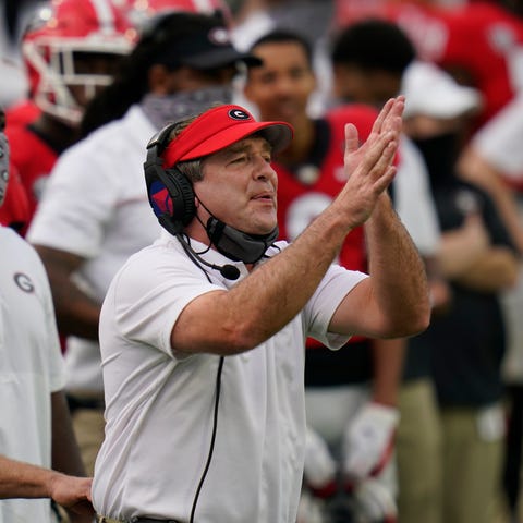 Georgia coach Kirby Smart signals to his players d