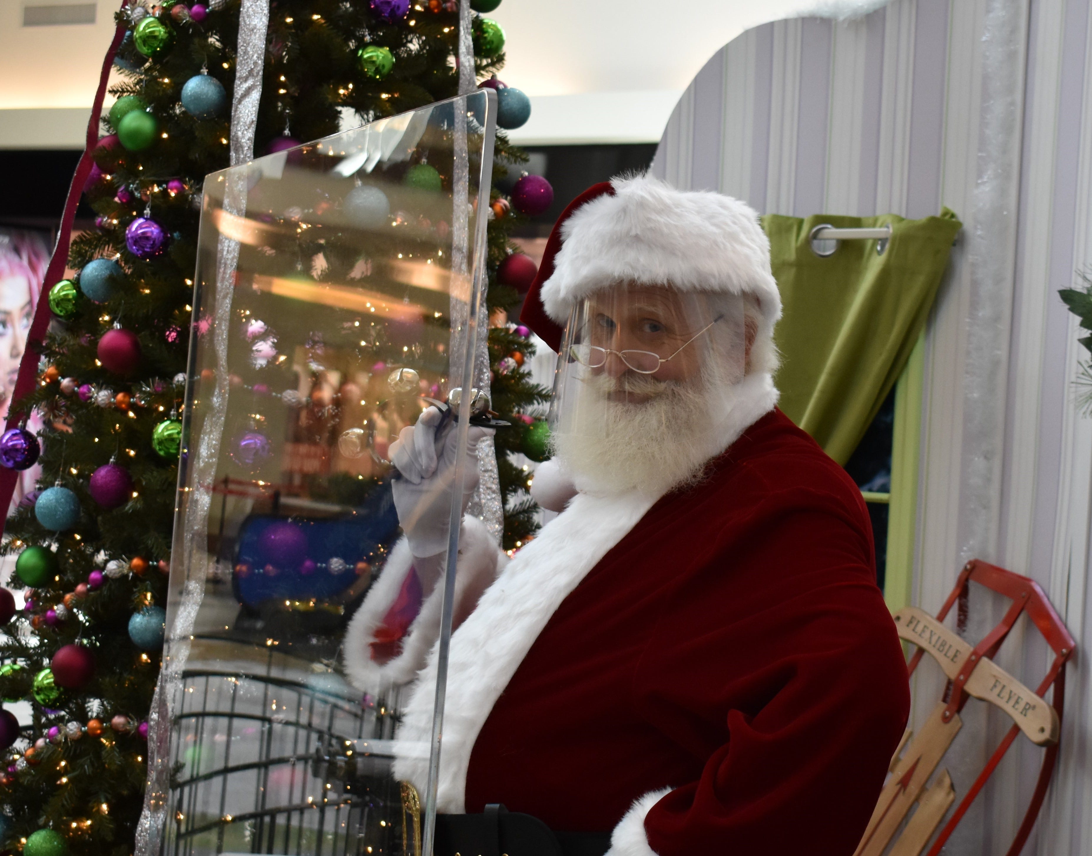 Cherry Hill Mall Christmas 2022 Santa Claus Wears A Face Mask And Sits Behind A Plastic Shield This Year