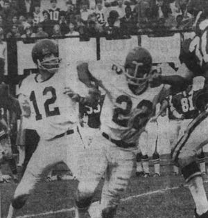 (AP PHOTO) Marshall University's Arthur Harris (22) blocks quarterback Bob Harris (unrelated) during a football game on November 14, 1970 at the University of East Carolina.  Published in The Sunday Record, November 15, 1970 edition.