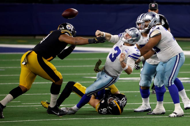 Pittsburgh Steelers' Stephon Tuitt, left, and linebacker T.J. Watt (90) pressure Dallas Cowboys quarterback Garrett Gilbert (3) who throws a pass to Ezekiel Elliott (21) as center Joe Looney (73) and guard Connor Williams, right rear, look on during the play in the second half of an NFL football game in Arlington, Texas, Sunday, Nov. 8, 2020. (AP Photo/Ron Jenkins)