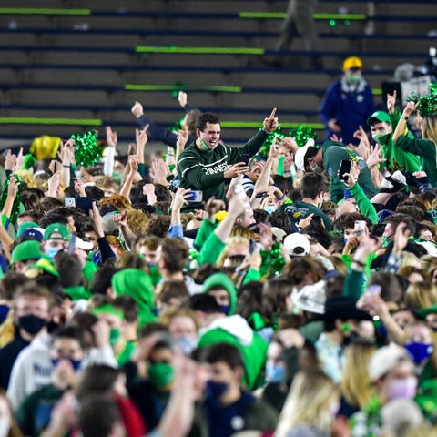 Students and fans storm the field after Notre Dame