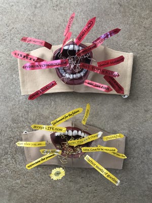 The "UnMasked Project" portion of the "Hope" exhibit at Cotuit Center for the Arts will include two masks created by Dale Michaels Wade. Together, they are titled "Reality Is What You Make It." The mask with the red words is called "I Just Want to Scream" and the one with the yellow words is "The Antidote."