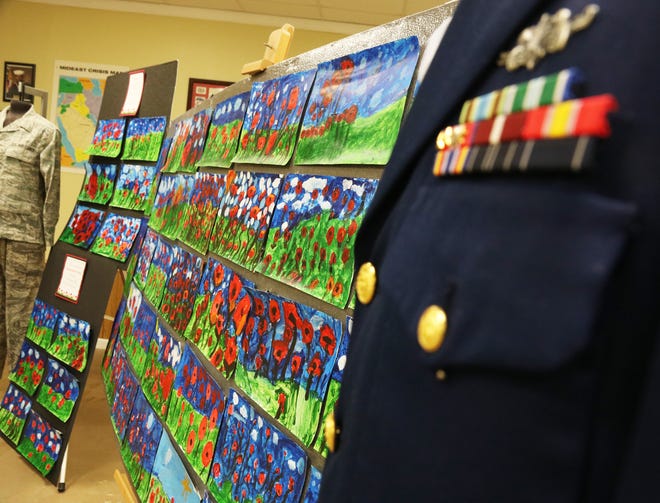 Paintings of poppies based on John McCrae's poem "In Flanders Fields" are on display at the G.I. Joe's Military Living History Museum, which were painted by 45 Arendell Parrott Academy first graders in art teacher Samantha Rouse's class for Veterans Day.
