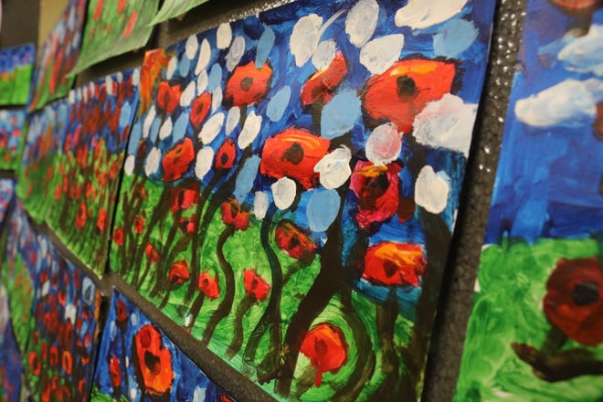 Paintings of poppies based on John McCrae's poem "In Flanders Fields" are on display at the G.I. Joe's Military Living History Museum, which were painted by 45 Arendell Parrott Academy first graders in art teacher Samantha Rouse's class for Veterans Day. [Brandon Davis/Kinston Free Press]