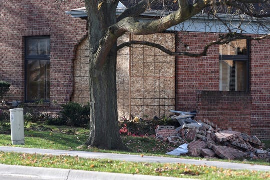 A car crash collapsed the brick exterior of the Estes Leadley Funeral Home in Holt early Sunday morning.