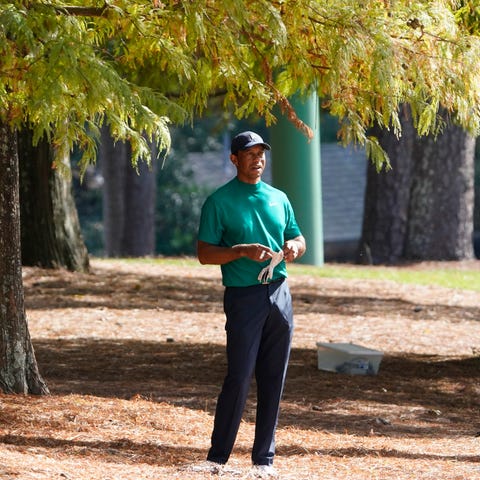 Tiger Woods looks over his second shot on the 13th