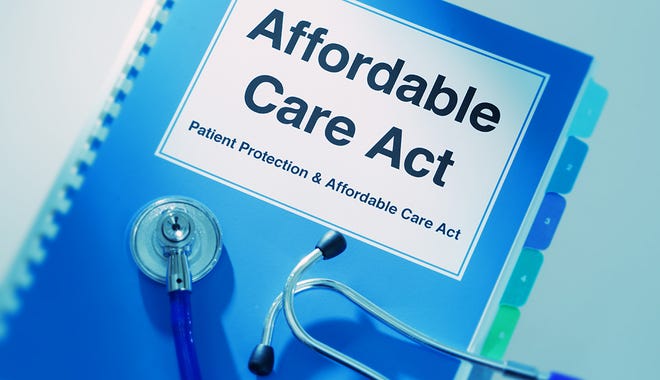 Close-up of a medical stethoscope laying on top of a Affordable Care Act Manual Book.