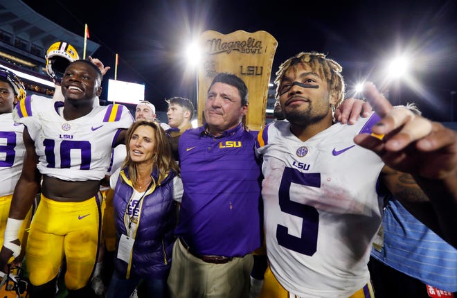 In this 2017 file photo, LSU head coach Ed Orgeron celebrates with running back Derrius Guice (5) following their 40-24 win over Mississippi in an NCAA college football game in Oxford, Miss.