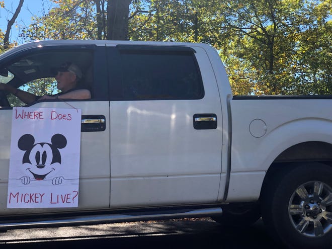 On Halloween, Troy community members decorated their cars with signs for a parade to surprise Landon Matheny with a wish of his lifetime: a trip back to Disney World. About 15 vehicles paraded the rural country road with signs, such as "Where does Mickey live?", hinting at the surprise.