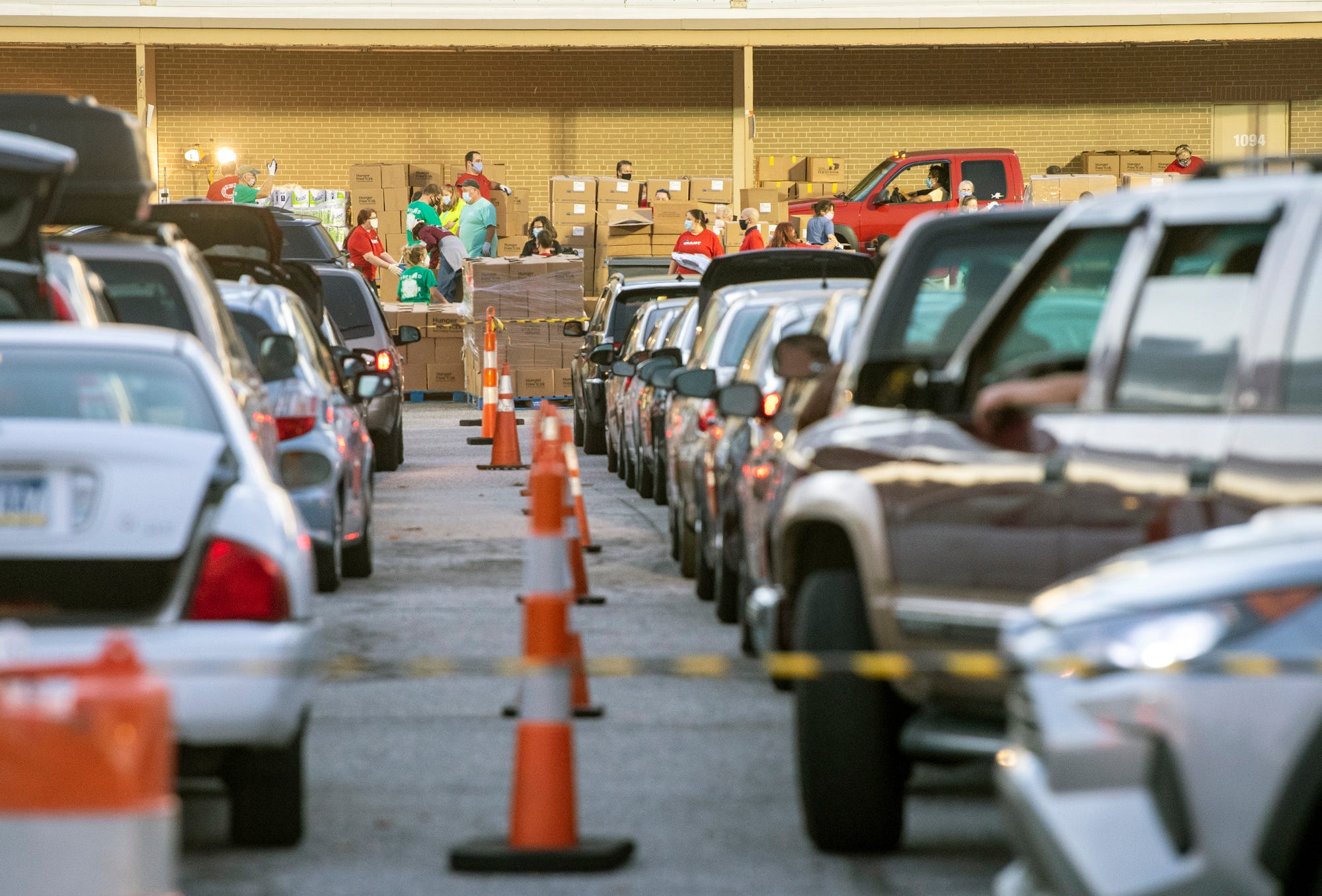 Cars wait in line for the regular Tuesday food distribution at the York County Food Bank in Springettsbury Township.