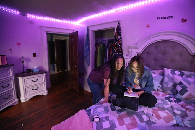 Zumarie Sepulveda checks on daughter Reina, a senior at East High School in Rochester, New York, during her anatomy class on Oct. 19, 2020. Public schools in Rochester were all-remote first semester, but some may shift to a hybrid schedule this semester.