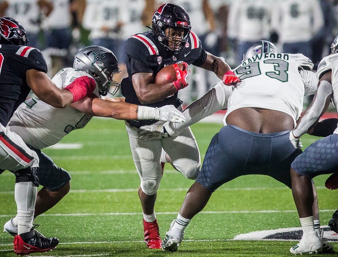 Ball State's Caleb Huntley fights past Eastern Michigan's defense during their game at Scheumann Stadium Wednesday, Nov. 11, 2020. 