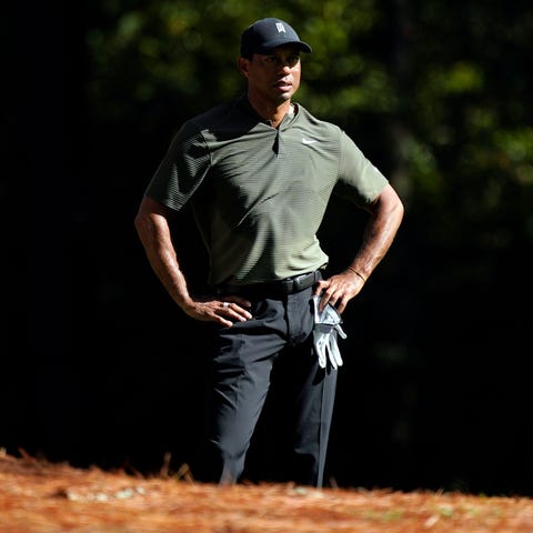 Tiger Woods looks over his second shot on the 11th
