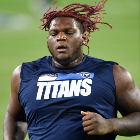 Tennessee Titans tackle Isaiah Wilson (79) warms u