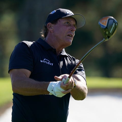 Phil Mickelson watches his shot from the third tee