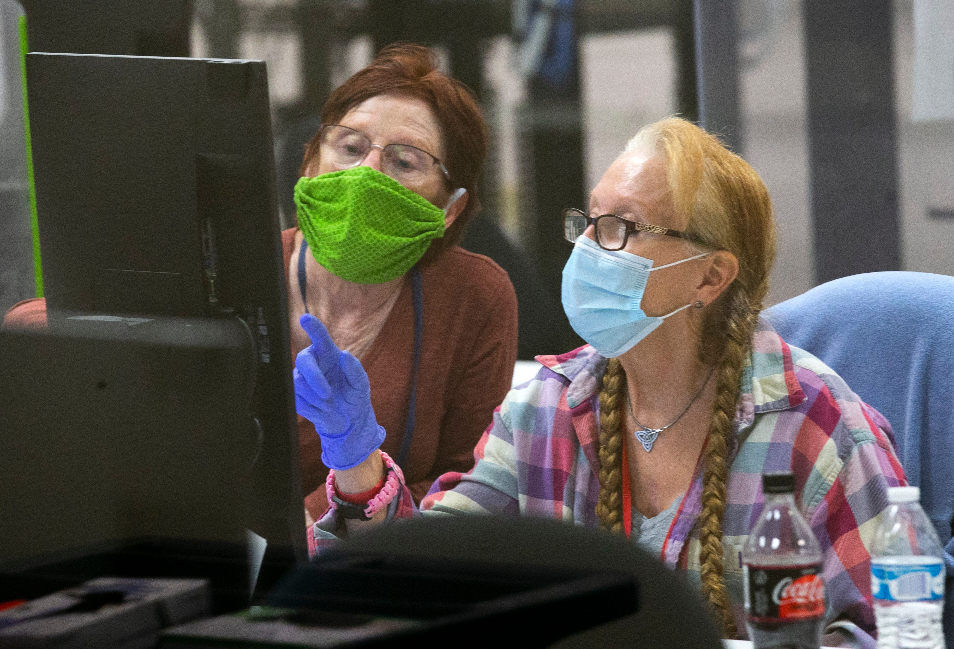 Maricopa County Elections adjudicators check ballots with individual contests in question to determine the voters' intent at the Maricopa County Elections headquarters in Phoenix, on Nov. 12, 2020. The adjudicators work in pairs, a registered Republican and a registered Democrat.