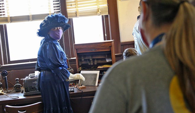 Isamari Carrera, left, talks to visitors at the Railway Museum of San Angelo about the history of the location during a living history event Saturday, Nov. 14, 2020.