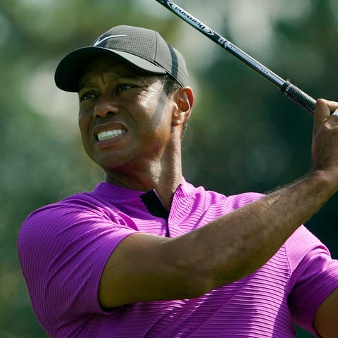 Tiger Woods plays his shot from the eighth tee dur