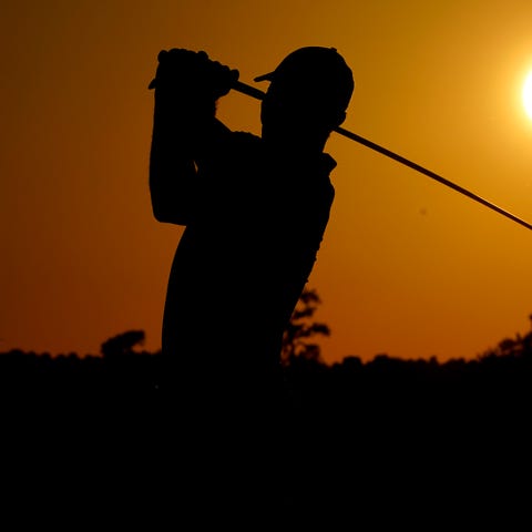 Tiger Woods plays his shot from the 10th tee durin