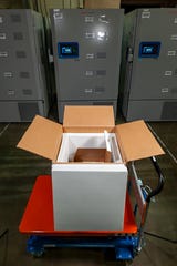 Pfizer's COVID-19 vaccine is being shipped in specially designed, insulated containers that hold between 195 and 975 five-dose vials and are about the size of a carry-on suitcase. The vials are stored in flat, pizza box-sized compartments, each of which holds 195 vials. A fully-loaded thermal container, which is reusable, contains five of these and weighs about 70 pounds.
