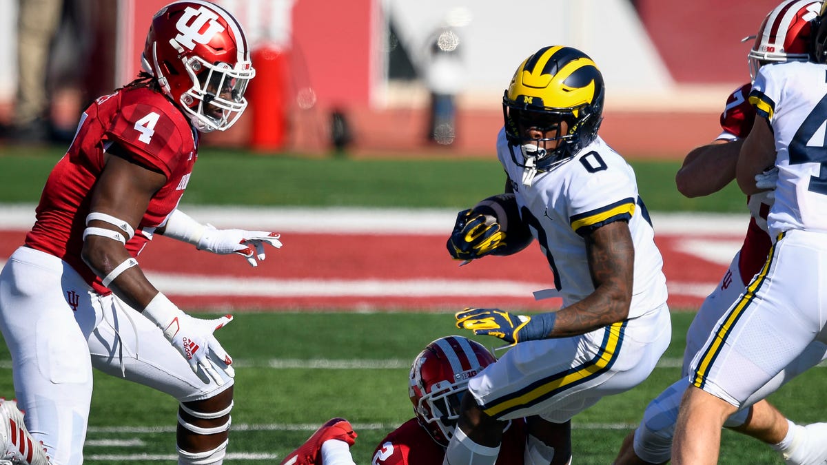 Michigan wide receiver Giles Jackson (0) is tackled by Indiana defensive back Reese Taylor during the first quarter of their game at Memorial Stadium.