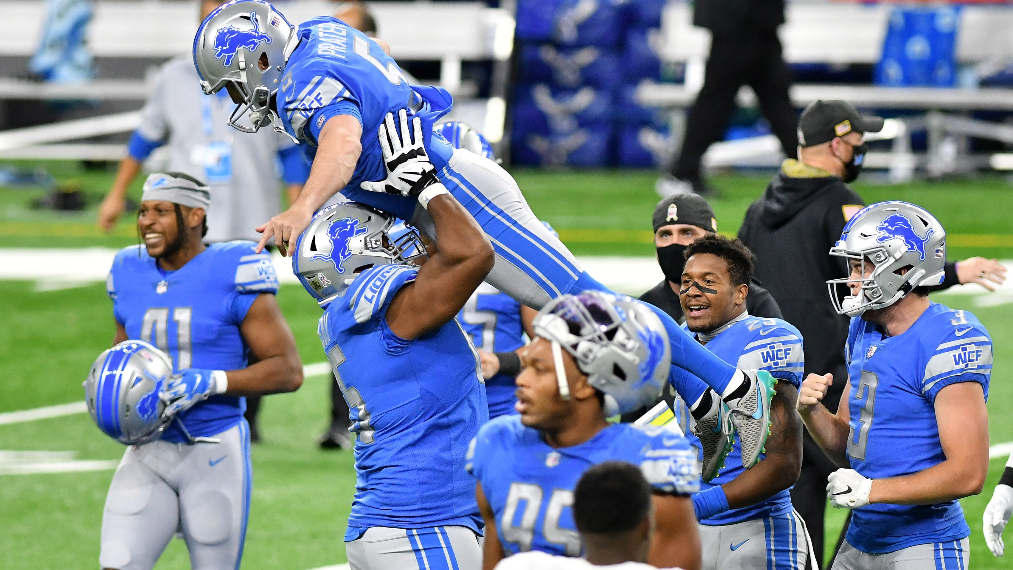 The Lions' Tyrell Crosby celebrates with kicker Matt Prater after the winning field goal as time expires.