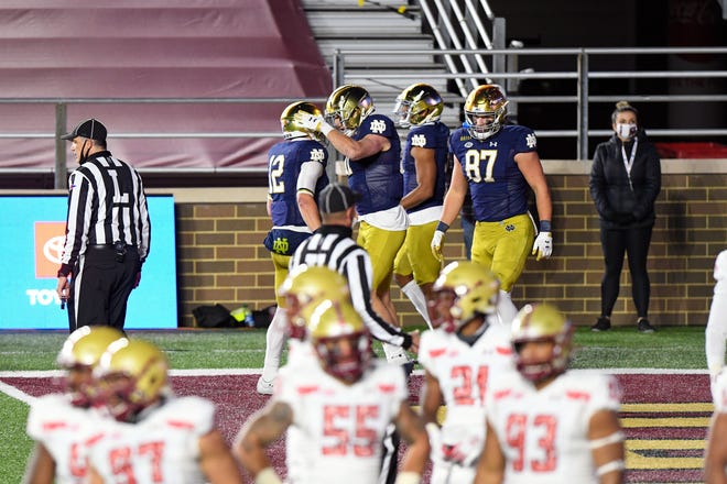 Notre Dame Fighting Irish wide receiver Ben Skowronek (11) celebrates with quarterback Ian Book (12) after scoring a touchdown against the Boston College Eagles during the first half at Alumni Stadium.