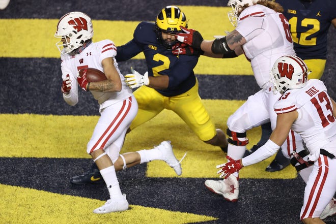 Badgers receiver Danny Davis beats Michigan's Carlo Kemp for a touchdown. The game was one of just two in which Davis played in 2020.