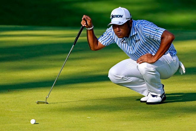 Nov 14, 2020; Augusta, Georgia, USA; Hideki Matsuyama lines up his putt on the tenth green during the third round of The Masters golf tournament at Augusta National GC. Mandatory Credit: Rob Schumacher-USA TODAY Sports