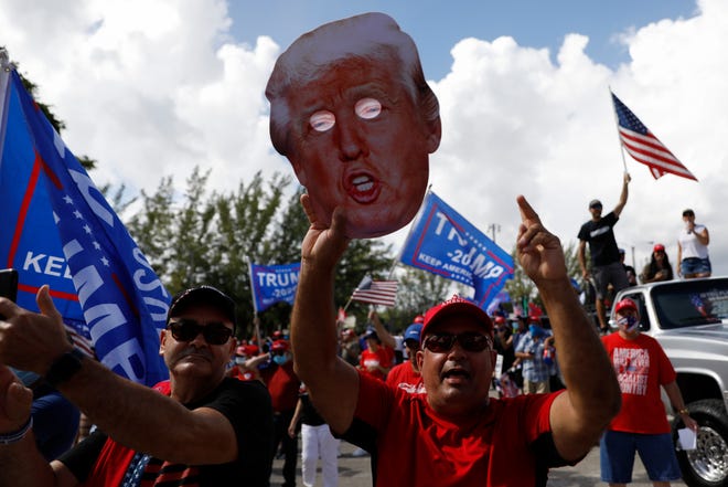 Supporters of President Donald Trump rally ahead of the start of a car caravan at Tropical Park in Miami on Nov. 1. Many Latino Trump supporters fear widespread election fraud may have robbed Trump of victory.