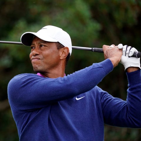 Tiger Woods plays his shot from the 18th tee durin