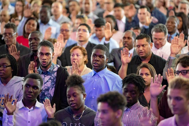 The Oath of Allegiance is administrated by the U.S. Citizenship and Immigration Services to 522 people from 65 different countries at the South Florida Fair Tuesday in West Palm Beach, January 22, 2019.  [ALLEN EYESTONE/palmbeachpost.com]