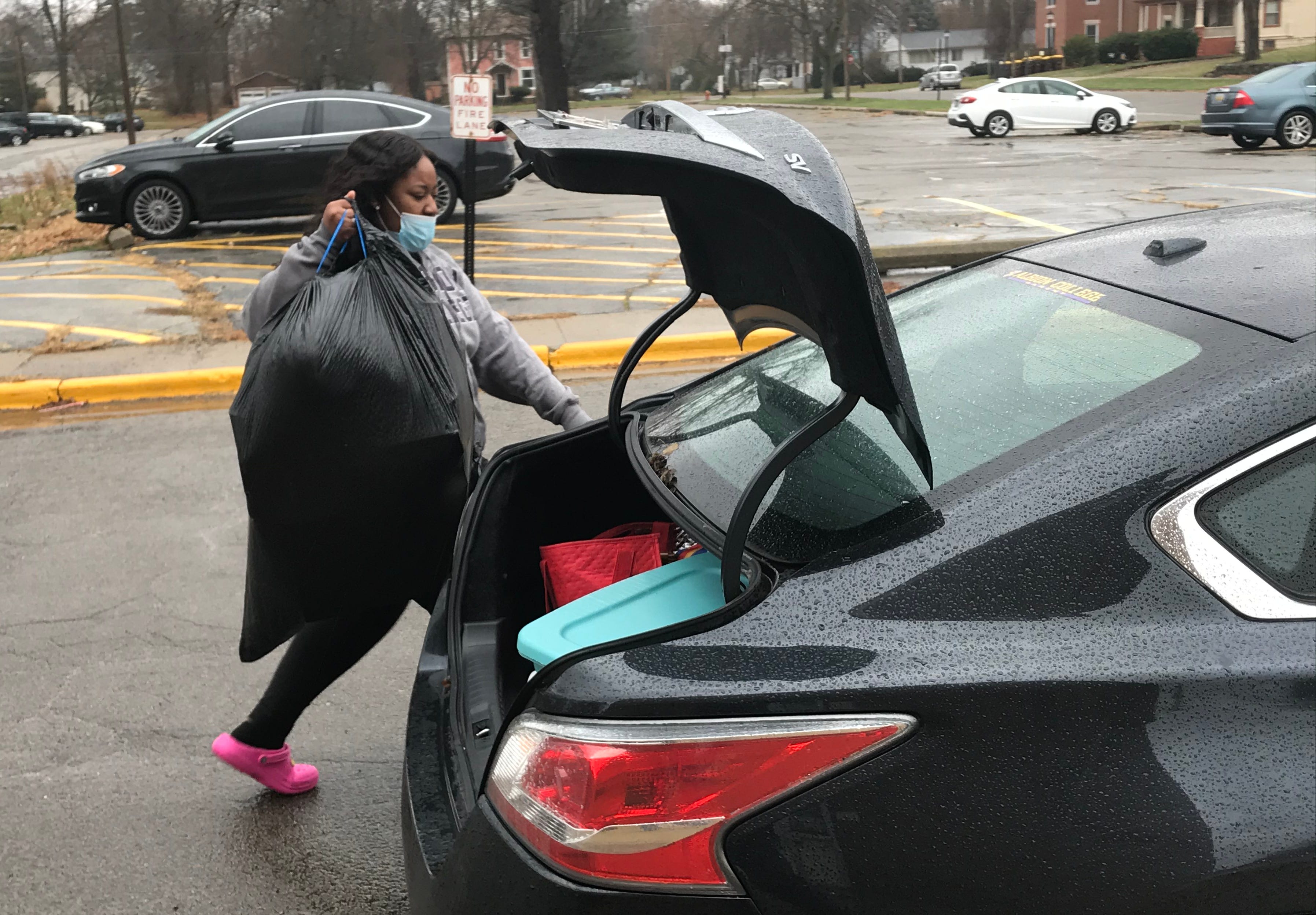 Jada Stewart, a junior at Albion College, loads her belongings into her mother's car on Nov. 15 as she moves back to her home in Chicago.