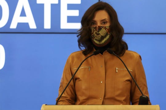 Gov. Gretchen Whitmer speaks during a press conference Sunday.  The Michigan Department of Health and Human Services issued a new emergency order that enacts a three-week pause targeting indoor social gatherings and other group activities in an effort to curb rapidly rising COVID-19 infection rates.