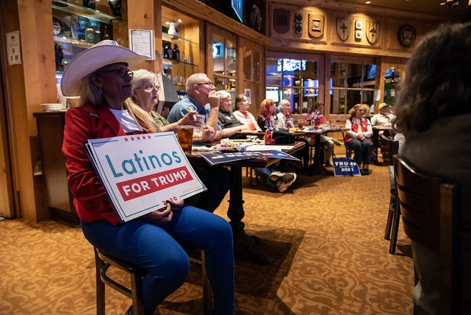 Latino Trump voters fear stolen election amid fraud conspiracies 3 A woman holds a "Latinos for Trump" sign at a watch party for the final presidential debate between President Donald Trump and former Vice President Joe Biden on October 22, 2020, in San Antonio, Texas.