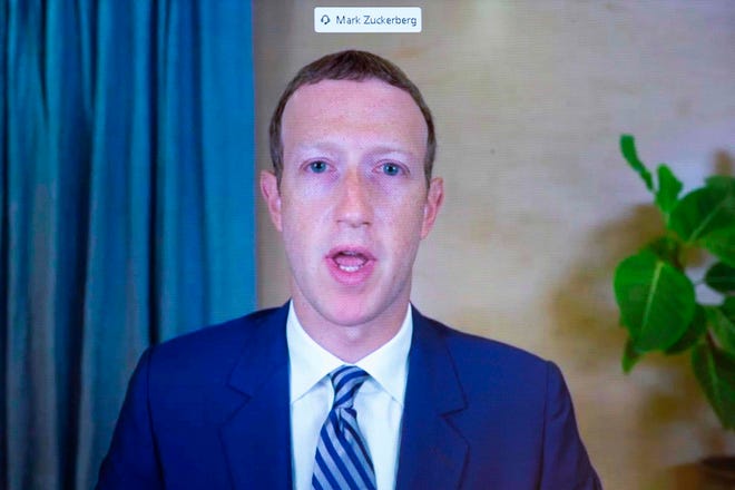 CEO of Facebook Mark Zuckerberg appears on a monitor as he testifies remotely during a Senate Commerce Committee hearing on Oct. 28. Senators and tech CEOs girded for a clash over a law making online services immune from liability for third-party content.