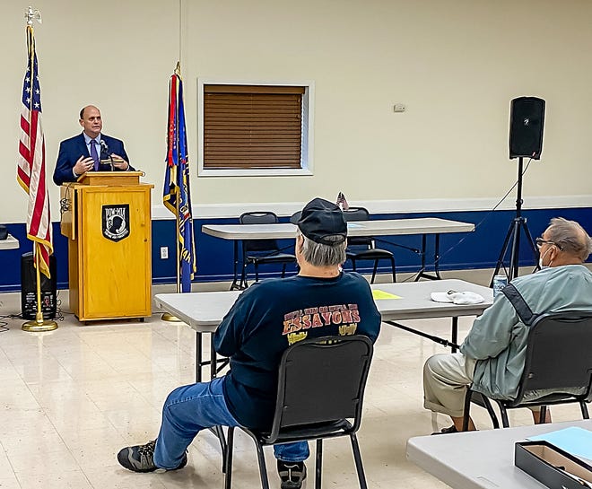 Members of the Corning VFW Post listen as U.S. Rep. Tom Reed speaks on Veterans Day, last week in Corning.